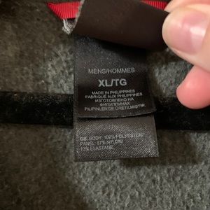 Gray half zip north face fleece with red zipper.